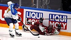 Kaza�ský obránce Jegor �alapov si p�ebírá kotou� vedle le�ícího loty�ského...