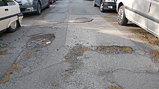 Rozbitá Záme�nická ulice v Praze 14.