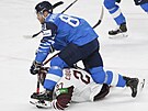 Finský útoník Iiro Pakarinen posílá k ledu lotyského hokejistu Oskarse...