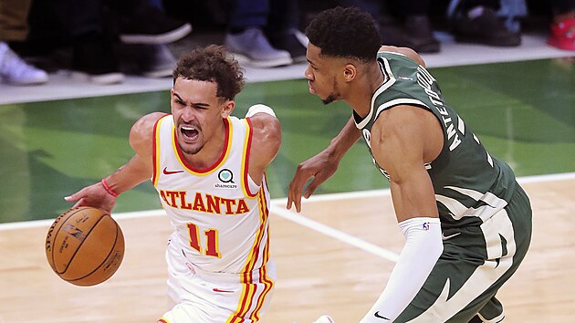 Trae Young z Atlanty se tla pes Janise Adetokunba z Milwaukee.