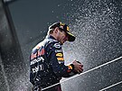 Nizozemský jezdec Red Bullu Max Verstappen u se ampaským oslavuje vítzství...