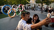 Lidé se tlačí kolem olympijských kruhů před olympijským stadionem kvůli fotce.