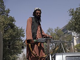 Tálibánský bojovník v Kábulu drží stráž před prezidentským palácem (16. srpna...