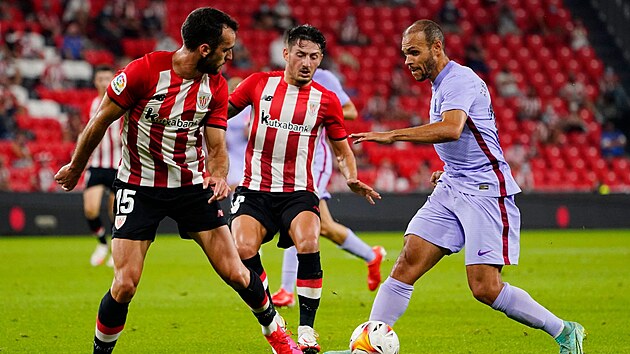 tonk Barcelony Martin Braithwaite (vpravo) se sna ve stylu Lionela Messiho pejt pes brnc hre Bilbaa.