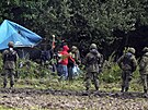 Migranti na hranici mezi Bloruskem a Polskem, které ve tvrtek vyhlásilo v...