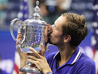 Rus Daniil Medveděv líbá trofej pro šampiona US Open.