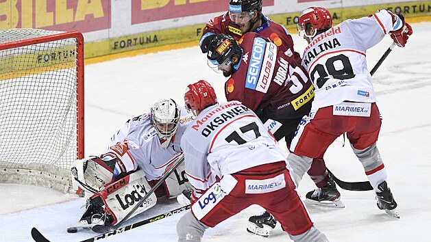 Utkn 11. kola hokejov extraligy: HC Sparta Praha - Mountfield Hradec Krlov. Uprosted Roman Hork ze Sparty dv gl branki Hradce Krlov tpnu Lukeovi (vlevo).