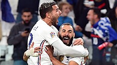 Théo Hernandez (vlevo) a Karim Benzema oslavují francouzský gól proti Belgii.