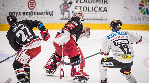 Utk�n� 17. kola hokejov� extraligy: HC Olomouc - HC Sparta Praha. Kuri�zn� moment p�ed g�lem Ladislava Zikmunda ze Sparty (vpravo). Zleva Alex Ra�ner z Olomouce a brank�� Olomouce Jan Luk�