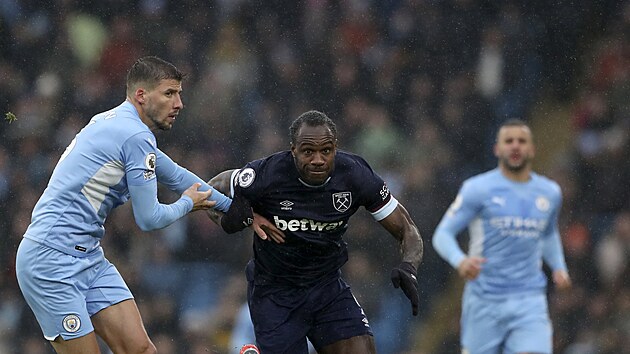 Michail Antonio z West Hamu sleduje míč, drží ho Ruben Dias z Manchesteru City.