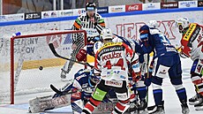 Kometa Brno (modrá) vs. Pardubice. Puk z hole Luká�e And�la (vpravo) mí�í do...