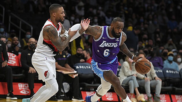 LeBron James (vpravo) z Los Angeles Lakers obchz  Damiana Lillarda z Portlandu.