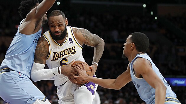 LeBron James z Los Angeles Lakers prochází mezi Jarenem Jacksonem Jr.,(vlevo) a De'Anthonym Meltonem z Memphisu.