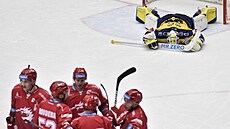 Třinečtí hokejisté slaví, zatímco zlínský Libor Kašík smutní.
