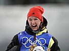 Rozjásaná nmecká biatlonistka Denise Herrmannová slaví triumf v olympijském...