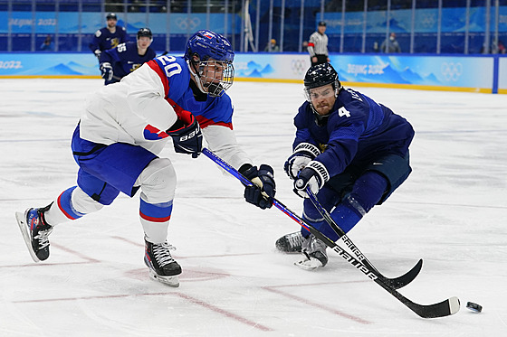 Slovenský forvard Juraj Slafkovský (20) posílá pihrávku kolem finského obránce...