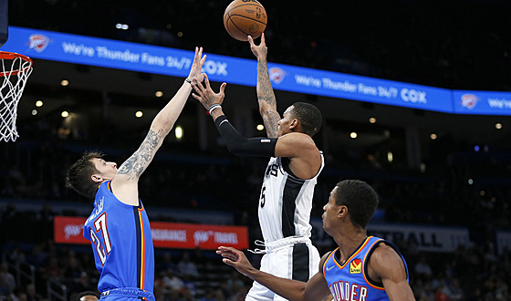Dejounte Murray ze San Antonia zakonuje, blokuje ho Vít Krejí z Oklahomy.