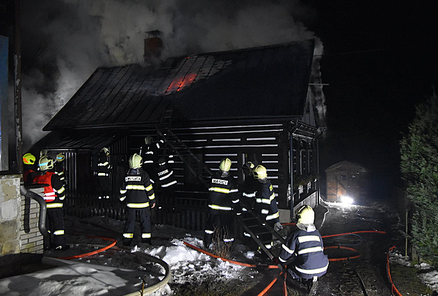 Majitelé odjeli a roubenka začala v noci hořet, hasiči rozebrali střechu