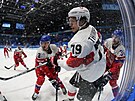 Olympijský turnaj mu v ledním hokeji. výcar Calvin Thurkauf (79) bojuje v...