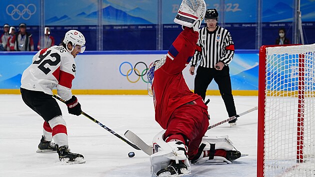 Olympijský turnaj mužů v ledním hokeji. Brankář České republiky Šimon Hrubec (11) blokuje poslední pokus Švýcara Gaetana Haase (92). (11. února 2022)