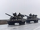 Vojenská vozidla jezdí po ulici v Mariupolu. (24. února 2022)