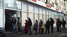 Lidé v Moskv stojí dlouhé fronty, aby si mohli vybrat peníze z bankomat. (27....