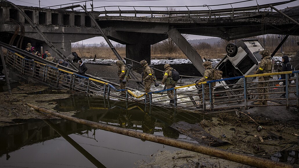 Ukrajintí vojáci pechází po znieném most v Kyjv. (2. bezna 2022)