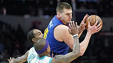 Nikola Joki (vpravo) z Denver Nuggets útoí v zápase s Charlotte Hornets,...