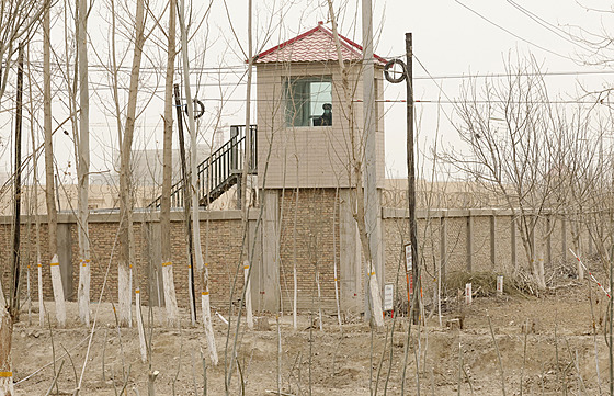 Pracovník ostrahy sleduje ze strážní věže okolí detenčního zařízení v Ujgurské...