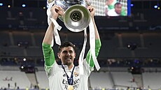 Thibaut Courtois, brankář Realu Madrid, křepčí s trofejí pro vítěze fotbalové...