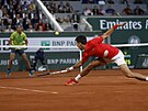 Srbský tenista Novak Djokovi doklouzává za kraasem panla Rafaela Nadala (v...