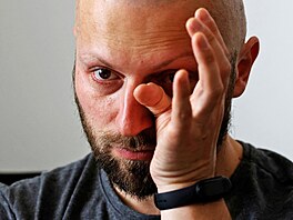 Territorial Defence member Oleksandr Zhygan, 37, turns emotional as he talks...