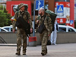 Territorial Defence members Oleksandr Zhygan, 37, and partner Antonina...