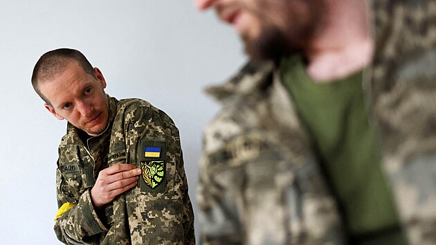 Territorial Defence members Oleksandr Zhygan, 37, and partner Antonina Romanova, 37, show a unicorn insignia on their uniforms symbolising the LGBTQ community, on the day of their departure to the frontline, as Russia's attack on Ukraine continues, at their home in Kyiv, Ukraine May 25, 2022.
