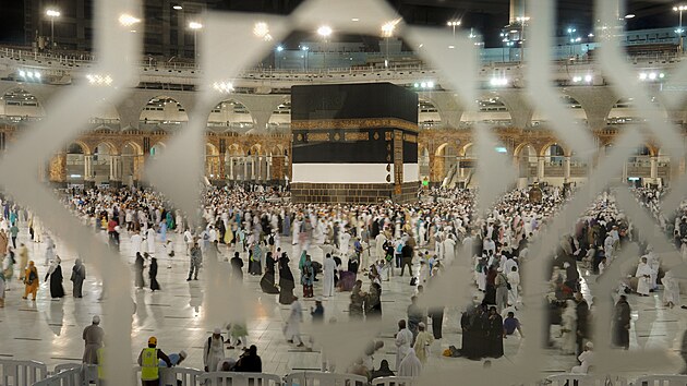 In this photo made with a slow shutter speed, Muslim pilgrims are seen through decorations on a glass window as they circumambulate around the Kaaba, the cubic building at the Grand Mosque, during the annual hajj pilgrimage, in Mecca, Saudi Arabia, Sunday, July 10, 2022. This year's pilgrimage marks the largest since the coronavirus struck, although the influx of 1 million worshippers remains less than half of the pre-pandemic attendance. (AP Photo/Amr Nabil)