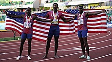 Vít�zný Fred Kerley (uprost�ed) se svými krajany a medailovými par�áky. Vpravo...