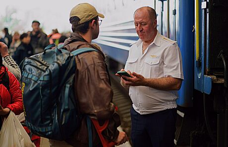 Prvodí v ukrajinském Lvov kontroluje doklady mue, který nastupuje do vlaku...