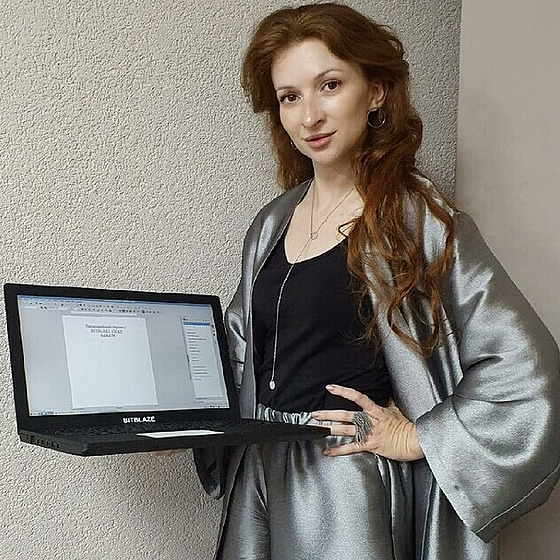 Obchodní ředitelka společnosti Bitblaze ukazuje nový ruský notebook Titan BM15.