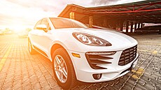 Compact white executive car, with business car, large chrome grille.