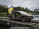 Ukrajintí výsadkái jedou na vozidle s ukrajinskou vlajkou na pontonovém most...