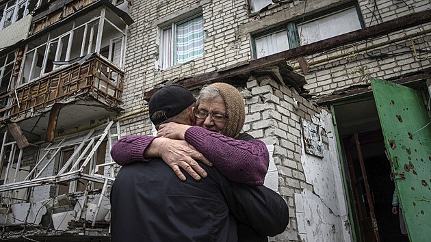 Žena se objímá se synem před zničeným domem v nedávno osvobozeném Izjumu na Ukrajině. (14. září 2022)