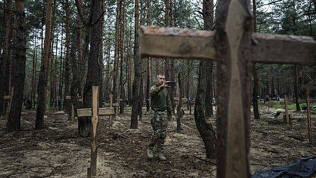 Oleg Kotenko, vldn zmocnnec pro otzky poheovanch osob za zvltnch okolnost, nat svm telefonem neidentifikovan hroby civilist a ukrajinskch vojk v nedvno znovudobytm mst Izijum. (15. z 2022)