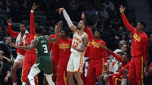 Basketbalist Atlanta Hawks se chystaj slavit trojku  Tyreseho Martina (22) v zpase s Milwaukee Bucks, brn George Hill.