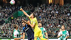 Branká Jií Pavlenka z Brém boxuje mí v utkání proti Hert.