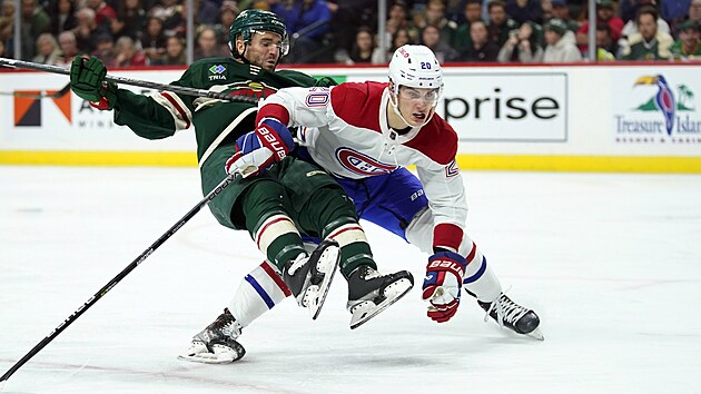 Minnesota Wild center Steven Fogarty (28) and Montreal Canadiens left wing Juraj Slafkovsky (20) collide while following the puck during the second period of an NHL hockey game Tuesday, Nov. 1, 2022, in St. Paul, Minn. (AP Photo/Abbie Parr)
