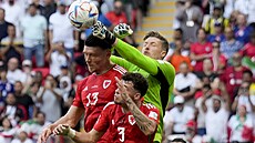 Velský branká Wayne Hennessey boxuje mí ped svými spoluhrái.