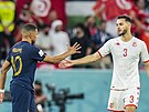 Francouz Kylian Mbappé a Tunisan Muntasar Talbí si podávají ruce po zápase.