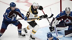 David Krejí (ve svtlém) z Boston Bruins ped bránou Colorado Avalanche