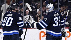 Branká�  David Rittich z Winnipegu se raduje se spoluhrá�em Pierrem-Lucem...