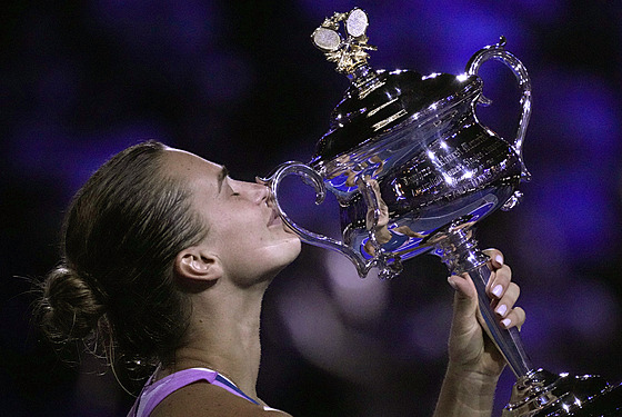 Aryna Sabalenková líbá trofej pro vítzku enské dvouhry na Australian Open.